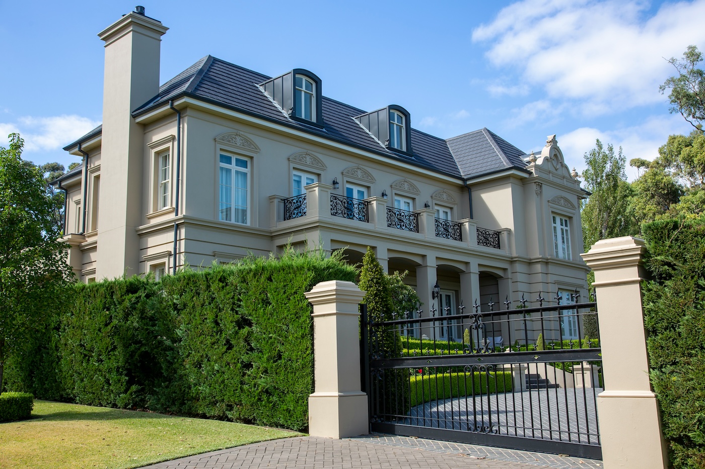 Elegant mansion with manicured landscaping.