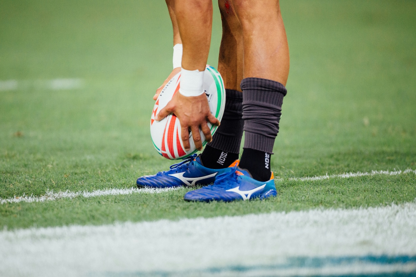 Player preparing to kick rugby ball