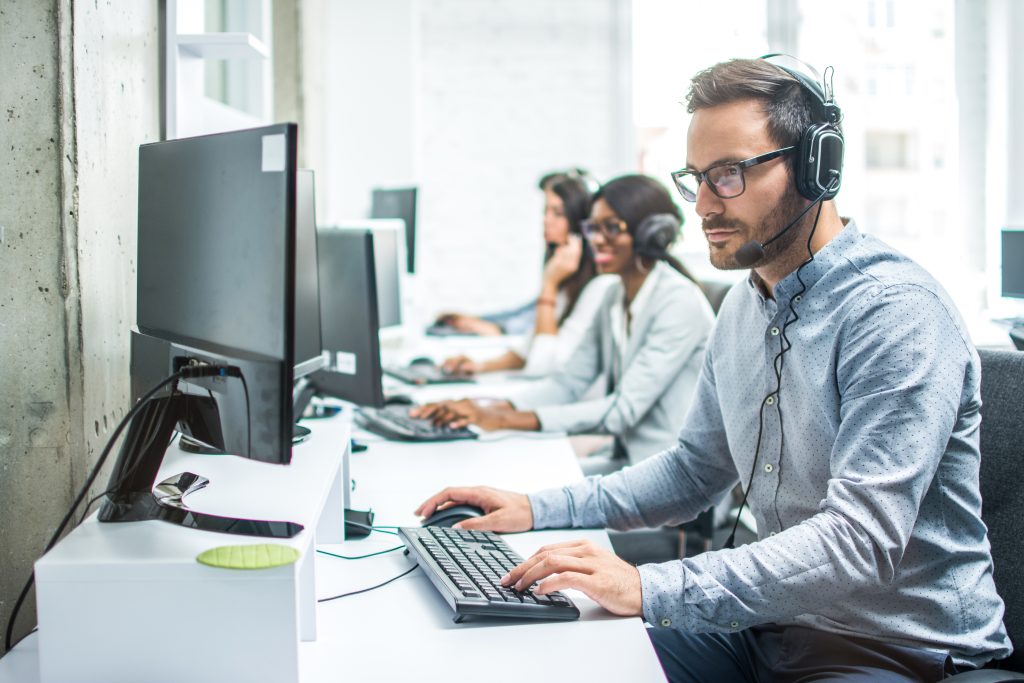 Handsome young male Emergency IT support executive working in office depicting Emergency IT Services for Businesses