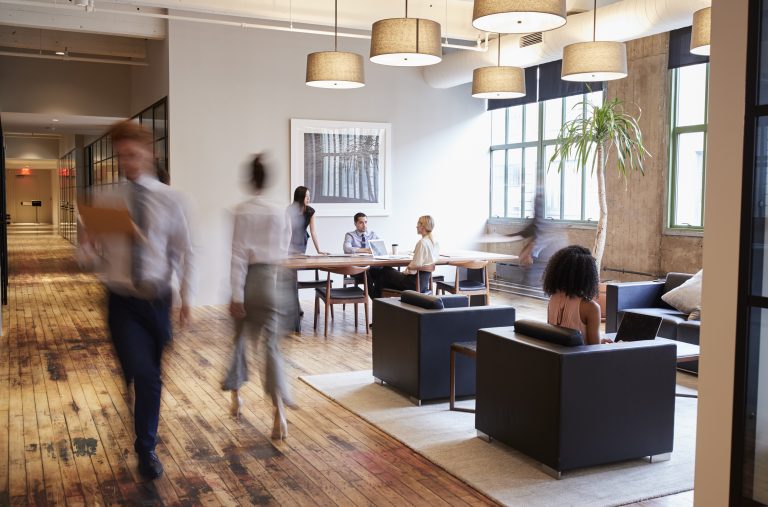Business people at work in a busy luxury office space, showcasing business type receiving Managed IT Services in Brampton